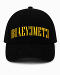 GORRA LETTERING — NEGRO AMARILLO — Negro amarillo